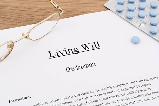 Living Will declaration document with medical pills and reading glasses for end-of-life healthcare decision documentation
